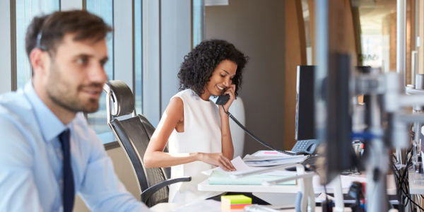 Two people are on the phone at work.