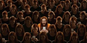 A large group of women all looking at their phones, with a spotlight on one in the middle.