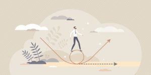 A person standing on a wheel made from an arrow following the path made by a different arrow.