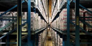 A long aisle with shelves holding boxes