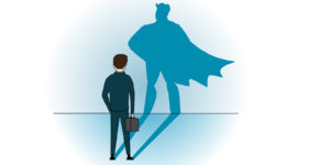 A person in a suit and tie standing in front of a wall with the shadow of a superhero.