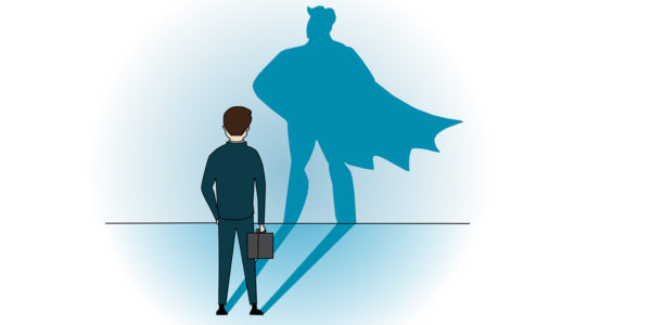 A person in a suit and tie standing in front of a wall with the shadow of a superhero.