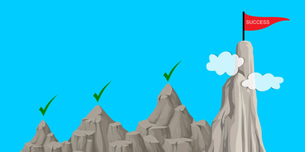 Four mountain peaks, three with a green check mark above them and the tallest has a red flag that reads “success”