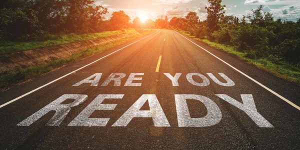 An image of a road with “Are You Ready?” painted on it.