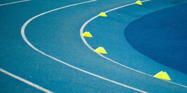 A blue track with yellow cones in each lane
