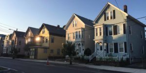 A row of houses side by side on a street