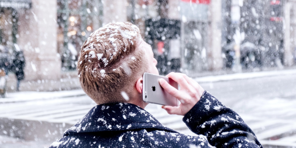 Call_in_the_Snow A man has his back turned as he is on the phone in a snow storm
