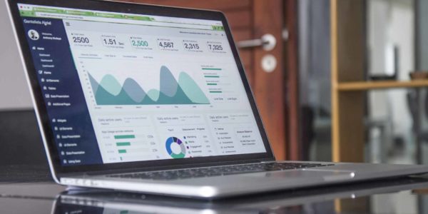 A laptop sits open, presenting an image of data.