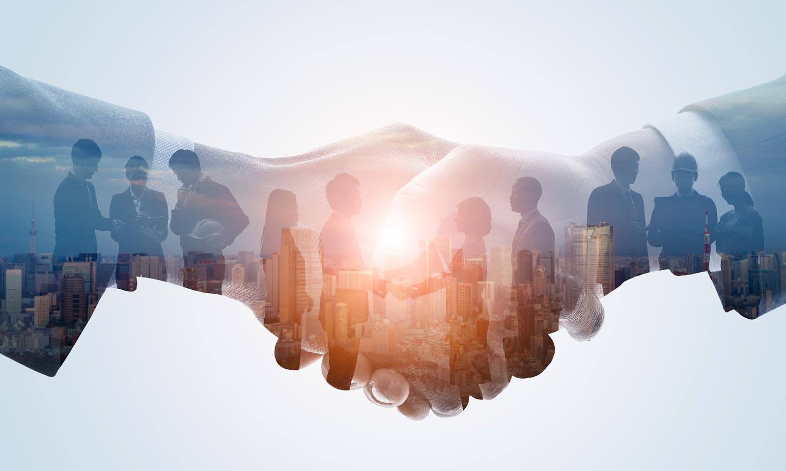 Ten people stand in a line covered by a slightly transparent handshake.