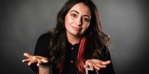 A woman in a black button up long sleeve shirt.
