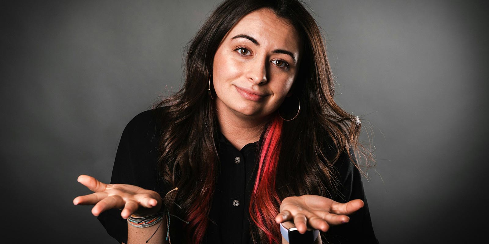 A woman in a black button up long sleeve shirt.