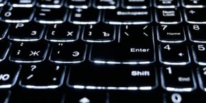 A close of a black and white keyboard.