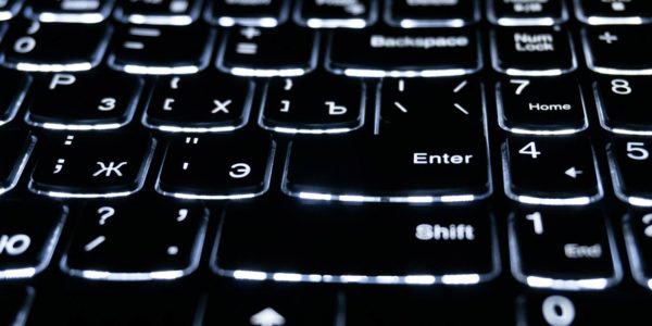 A close of a black and white keyboard.