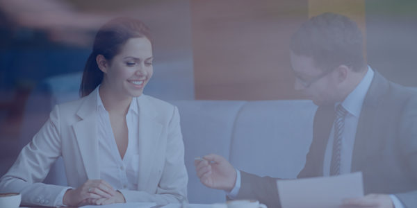 Two_Meet A man and a woman talk at a table.