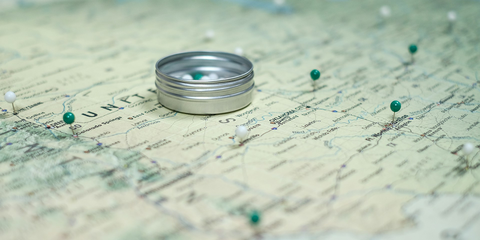 Green and white pins on a map.