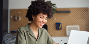Sales manager reviewing AI-generated coaching insights on a laptop with a sales rep to improve performance