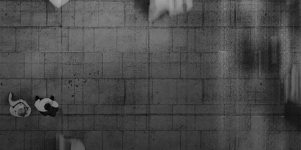 Overhead_View_People_Walking_On_Tiled_Pavement_Black_And_White_Abstract_Motion_Blur_Urban_Perspective Black and white overhead photo of people walking on a tiled pavement with motion blur creating an abstract urban perspective